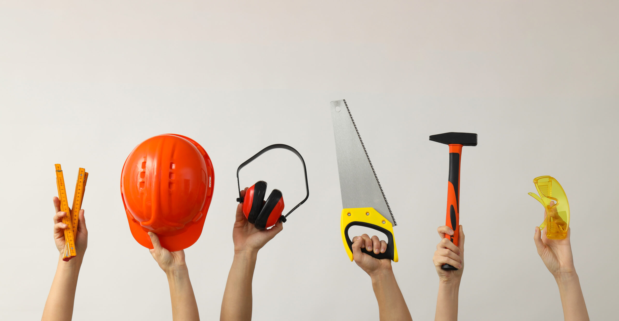 a variety of construction tools held in hands